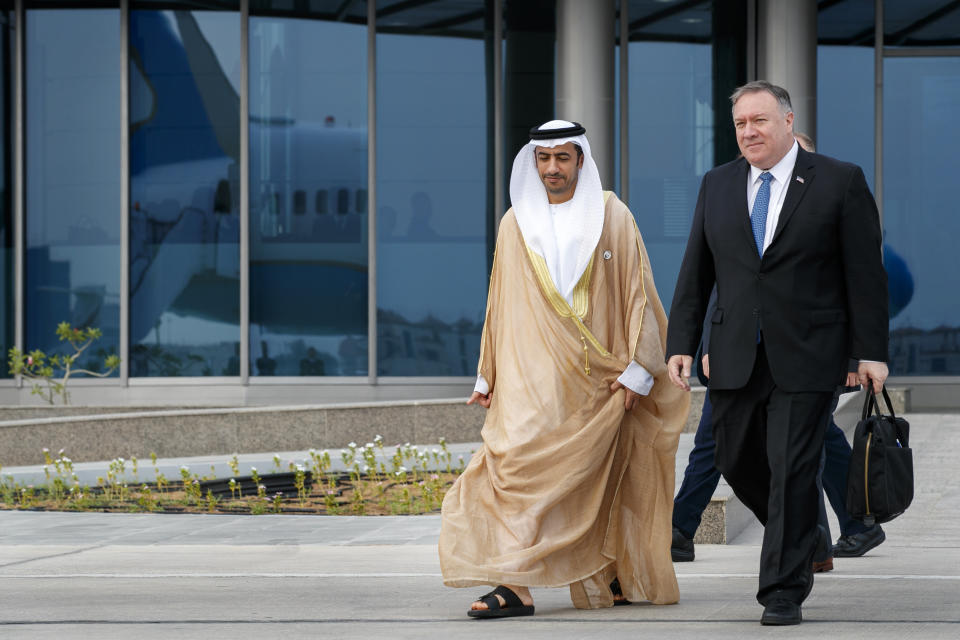 As his plane is reflected in the glass building behind them, Secretary of State Mike Pompeo, right, walks with Abu Dhabi Assistant Foreign Ministry Undersecretary for Protocol Affairs Shihad Al Faheem, as they say goodbye on the secretary's departure from Abu Dhabi, United Arab Emirates, Tuesday, June 25, 2019, en route to an undisclosed location. (AP Photo/Jacquelyn Martin, Pool)