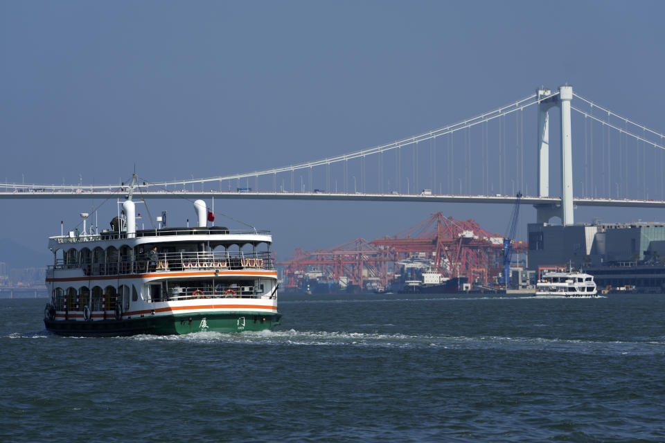 Ferries sail by a bridge near a port in Xiamen in southeast China's Fujian province on Dec. 26, 2023. The United Nations issued a somber global economic forecast for 2024 on Thursday, Jan. 4, 2024, pointing to challenges from escalating conflicts, sluggish global trade, persistently high interest rates and increasing climate disasters. (AP Photo/Andy Wong)