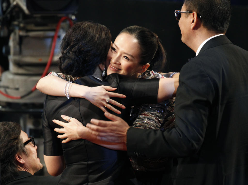 Chinese actress Zhang Ziyi celebrates with Hong Kong director Wong Kar Wai's wife after winning the Best Actress award for her role in the movie ' The Grandmaster ' at the at the 33nd Hong Kong Film Awards in Hong Kong, Sunday, April 13, 2014. At right is Hong Kong director Wong Kar Wai. (AP Photo/Vincent Yu)