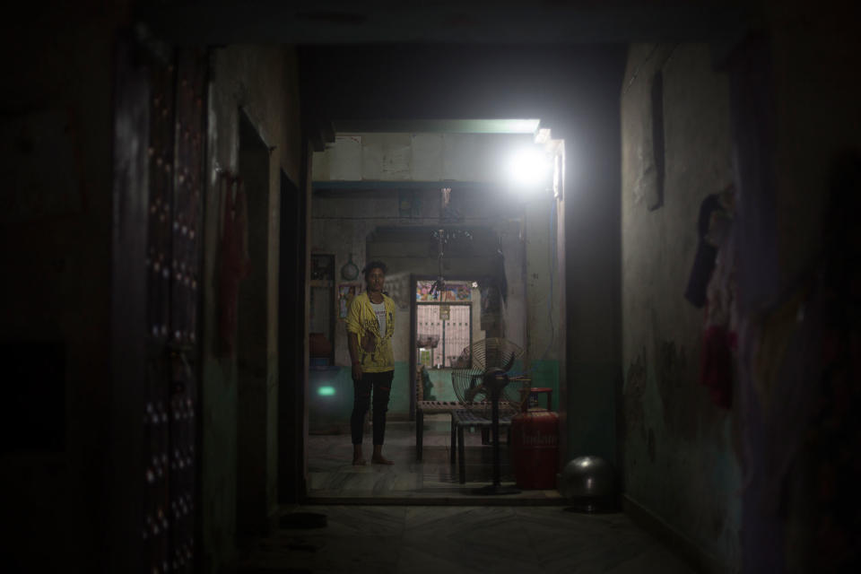 Ramgani Jat (18) stands in the middle of the main room of her parents’ house in Khankla, Bilwara district, Rajasthan, India in July 2016. She was secretly married when she was very young and her marriage became “effective” when she was 14. She fights with her father almost on daily basis because she wants to remain home and keep studying. She walks two hours a day to get to school. (Photo: Rafael Fabrés)