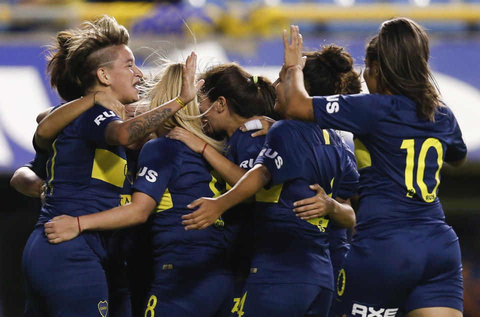 Boca Juniors' Noelia Espindola, not seen, celebrates scoring against Lanus with teammates during the Superliga women's tournament in Buenos Aires, Argentina, Saturday, March 9, 2019. The women competed in one of Argentina's most famous stadiums on Saturday, a milestone for the female players who are fighting for the same rights as male soccer players in the country's most popular sport. (AP Photo/Natacha Pisarenko)