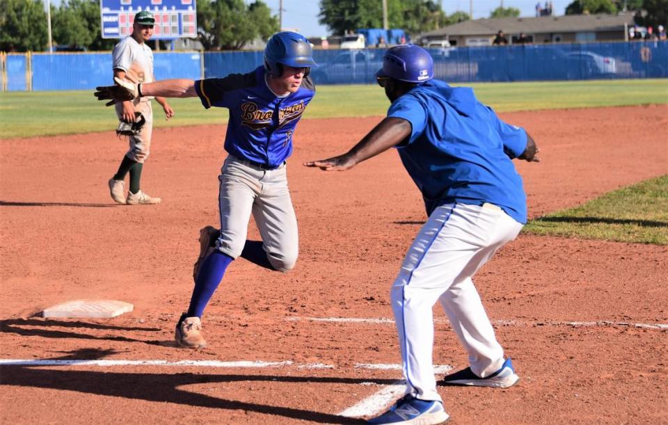 Dos Palos High School head coach Leonard Davis greets junior Drake Hennagan after Hennagan tied the Central Section Division III semifinal game against Dinuba in the sixth inning with a home run.