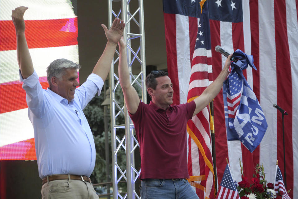 U.S. Senate candidate Trent Staggs, right, and Utah gubernatorial candidate Phil Lyman lead supporters in a "YMCA" dance during a rally on June 14, 2024, in Orem, Utah. (AP Photo/Rick Bowmer)