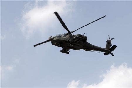 A military helicopter flies overhead during the military funeral service of police General Nabil Farag, who was killed on Thursday in Kerdasa, in Cairo's Nasr City district September 20, 2013. REUTERS/Mohamed Abd El Ghany