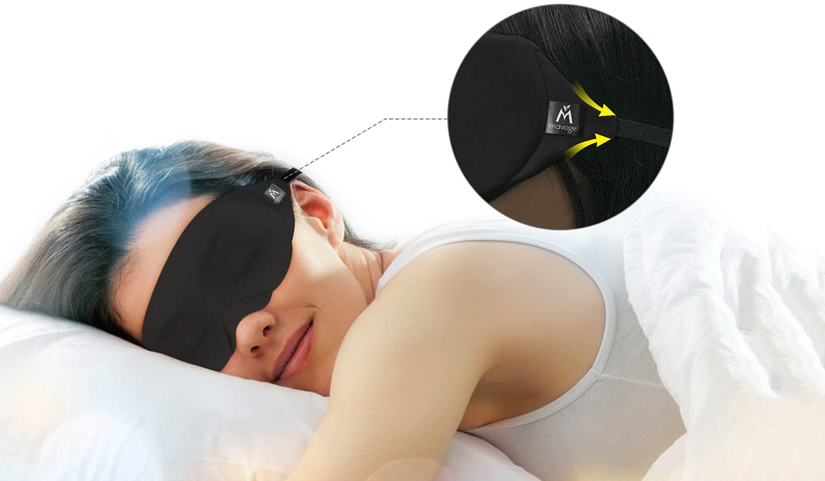 Model laying in bed wearing a black Mavogel sleep mask.