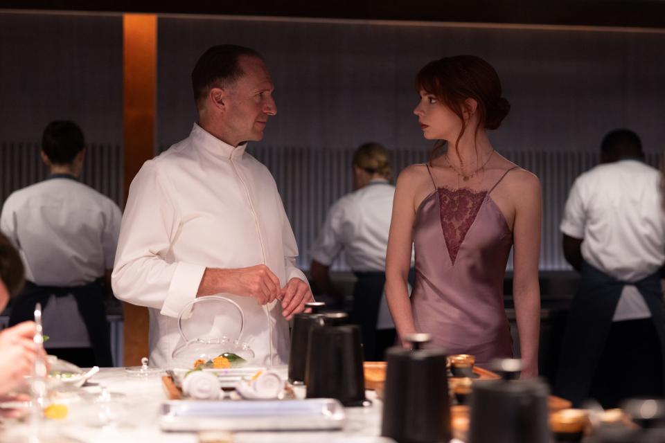 Ralph Fiennes, left, and Anya Taylor-Joy face off in fine-dining satire "The Menu."