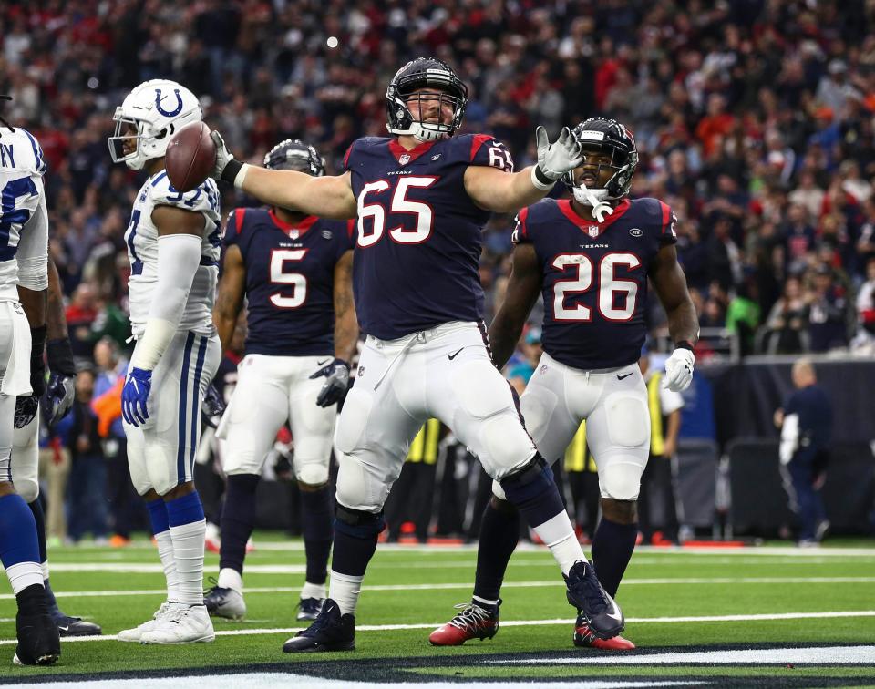 Houston Texans offensive guard Greg Mancz (65) spikes the ball after running back Lamar Miller (26) scores a touchdown during the third quarter against the Indianapolis Colts at NRG Stadium.