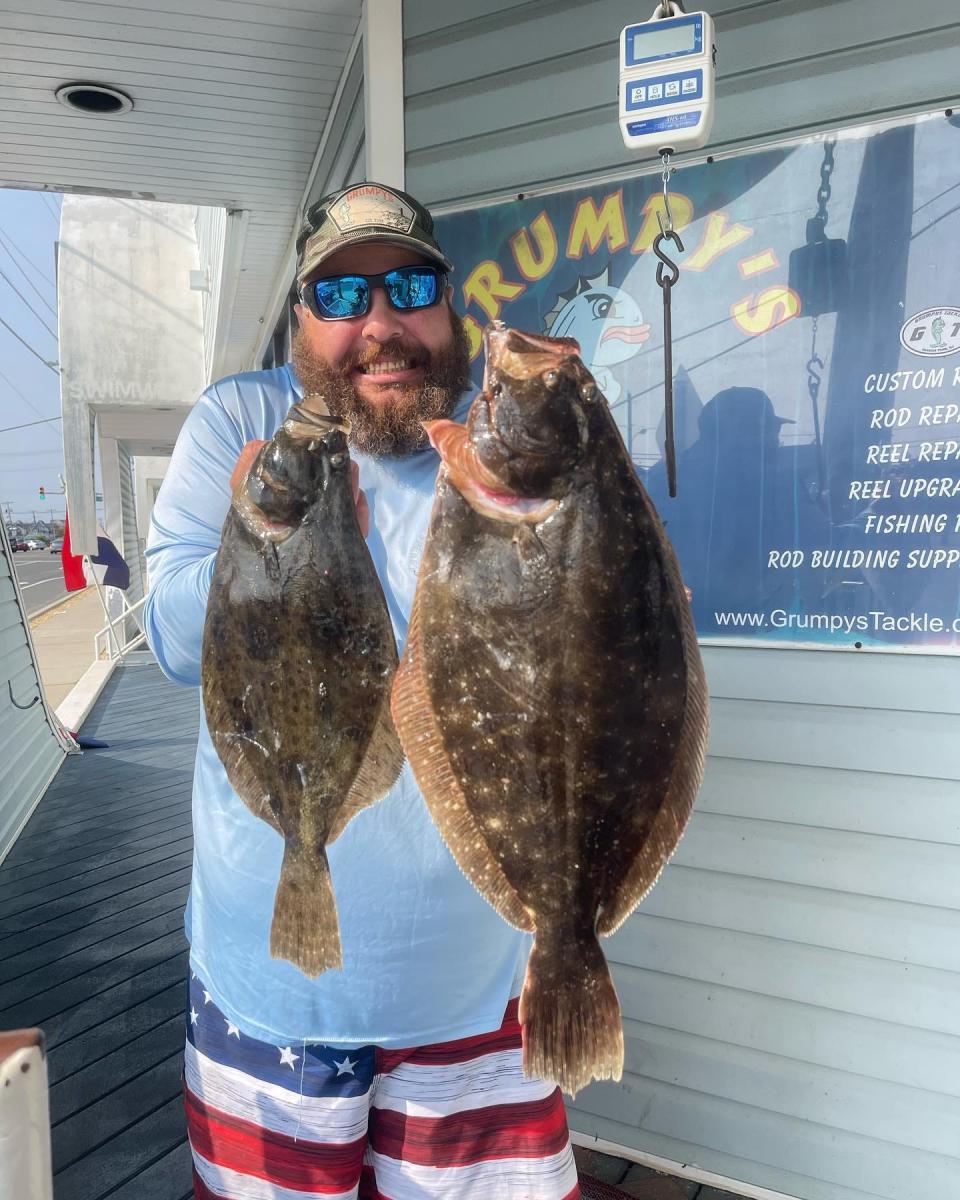 Scott Thomas weighs in a pair of fluke at Grumpy's Tackle in Seaside Park.