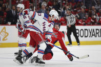 New York Rangers defenseman Adam Fox (23) collides with Washington Capitals center Hendrix Lapierre, front right, during the first period in Game 3 of an NHL hockey Stanley Cup first-round playoff series, Friday, April 26, 2024, in Washington. (AP Photo/Tom Brenner)