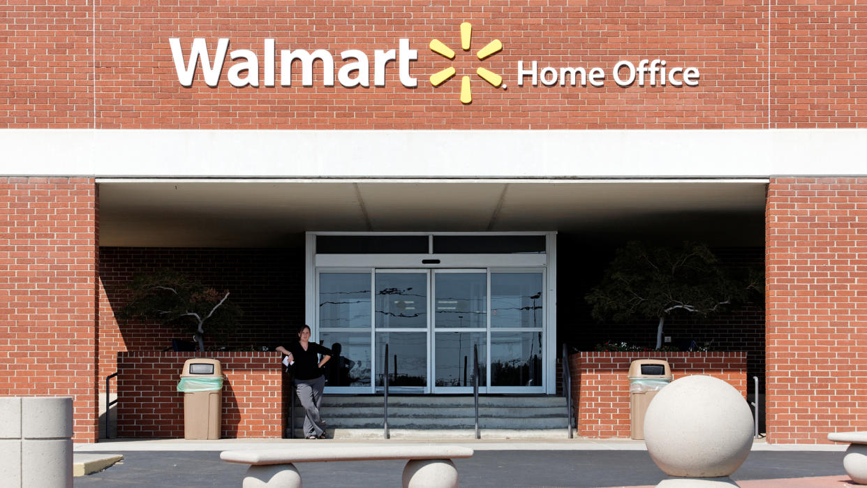 Bentonville, Arkansas, USA – October 4, 2012: An employee stands near the entrance to the Walmart Home Office in Bentonville.