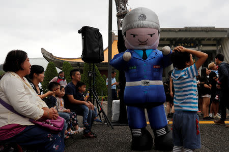 A performer dressed in a military honour guard mascot costume dances during a public fair which displays military equipments, in Taipei, Taiwan September 29, 2018. Picture taken September 29, 2018. REUTERS/Tyrone Siu