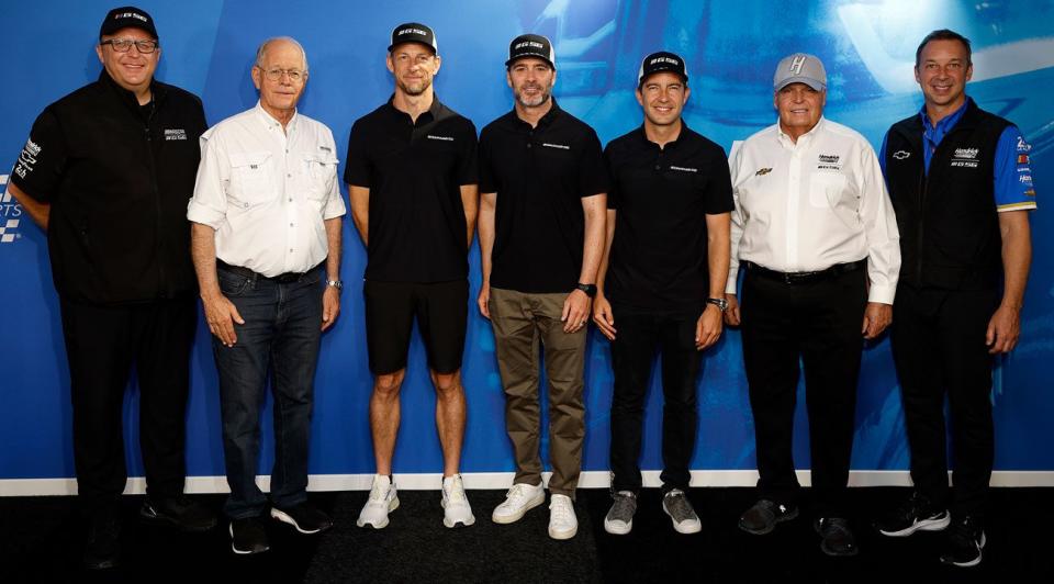 John Doonan, Jim France, Jenson Button, Jimmie Johnson, Mike Rockenfeller, Rick Hendrick and Chad Knaus stand and pose for a photo