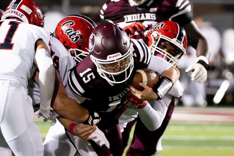 Canal Winchester quarterback Maxton Brunner tries to fight through Westerville South tacklers during his team's 35-14 win in Week 8.