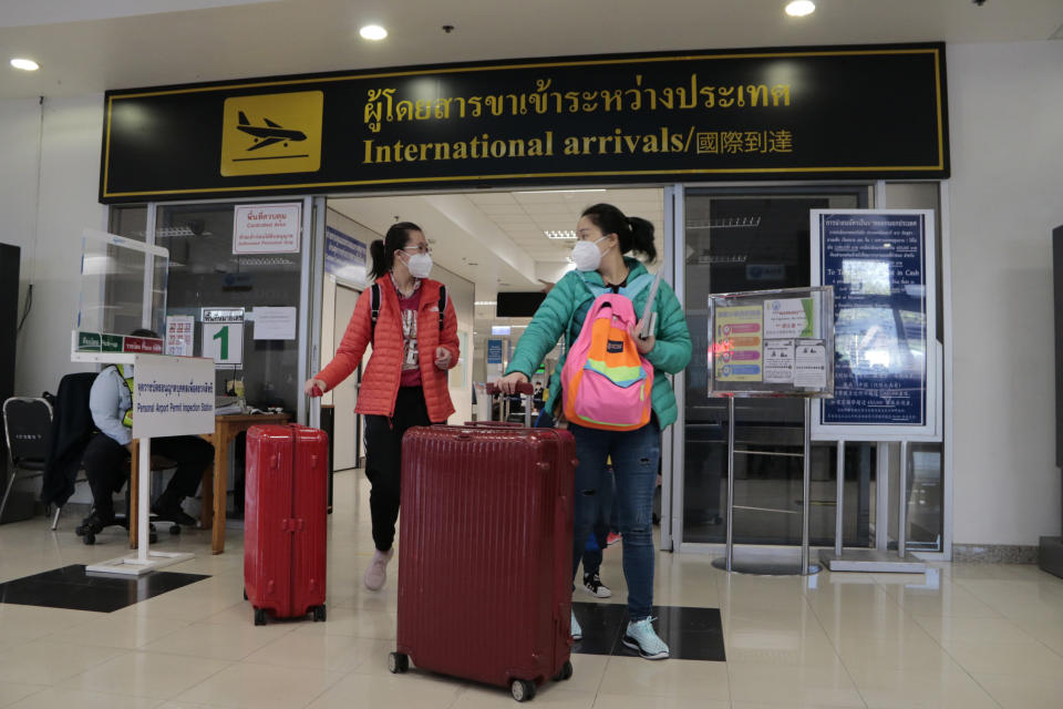 Chinese tourists arrive at Chiang Mai international airport in Chiang Mai province, northern Thailand, Thailand, Monday, Jan. 23, 2023. Just a handful of Chinese visitors were posing for photos and basking in the sun in the market and plazas near Chiang Mai’s ancient Tha Phae Gate, one of many tourist hotspots still waiting for millions of Chinese travelers to return. (AP Photo/Wichai Thaprieo)