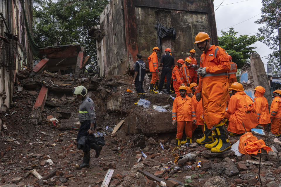 Rescuers look for survivors in the debris of a four-story residential building that collapsed in Mumbai, India, Tuesday, June 28, 2022. At least three people died and more were injured after the building collapsed late Monday night. (AP Photo/Rafiq Maqbool)