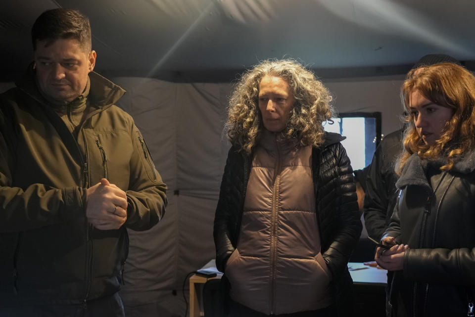 Chairman of Kherson region Yaroslav Yanushevych, left, and U.N. resident coordinator Denise Brown visit an evacuation coordinating point in the southern city of Kherson, Ukraine, Sunday, Nov. 27, 2022. (AP Photo/Sam Mednick)