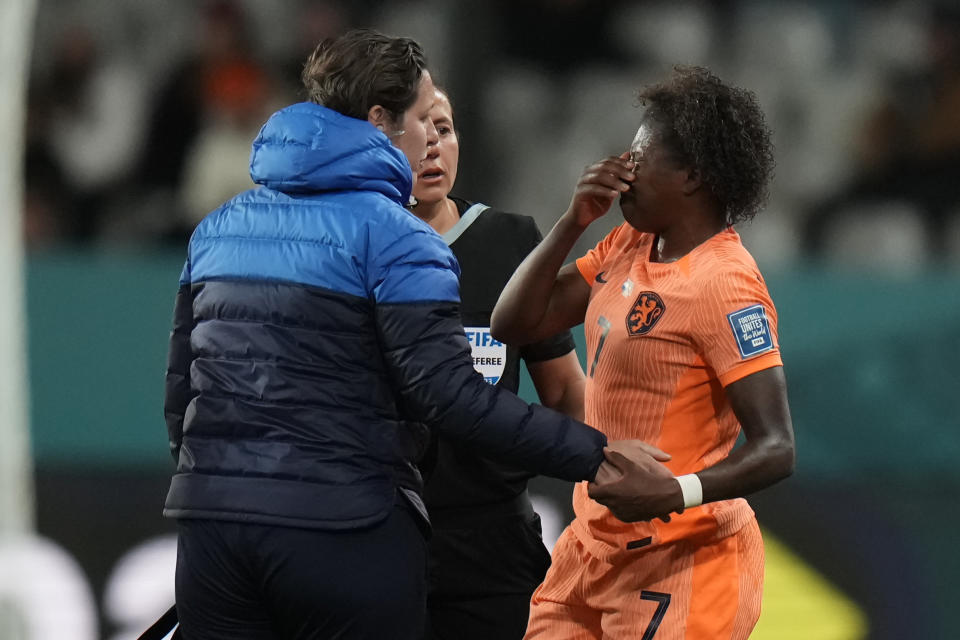 Netherlands' Lineth Beerensteyn, right, is attended to after sustaining an injury during the second half of the FIFA Women's World Cup Group E soccer match between the Netherlands and Portugal in Dunedin, New Zealand, Sunday, July 23, 2023. (AP Photo/Alessandra Tarantino)