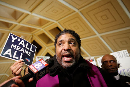 Civil rights leader Reverend William Barber, president of the NAACP in North Carolina, speaks to the media inside the state's Legislative Building as lawmakers gather to consider repealing the controversial HB2 law limiting bathroom access for transgender people in Raleigh, North Carolina, U.S. on December 21, 2016. REUTERS/Jonathan Drake/File Photo