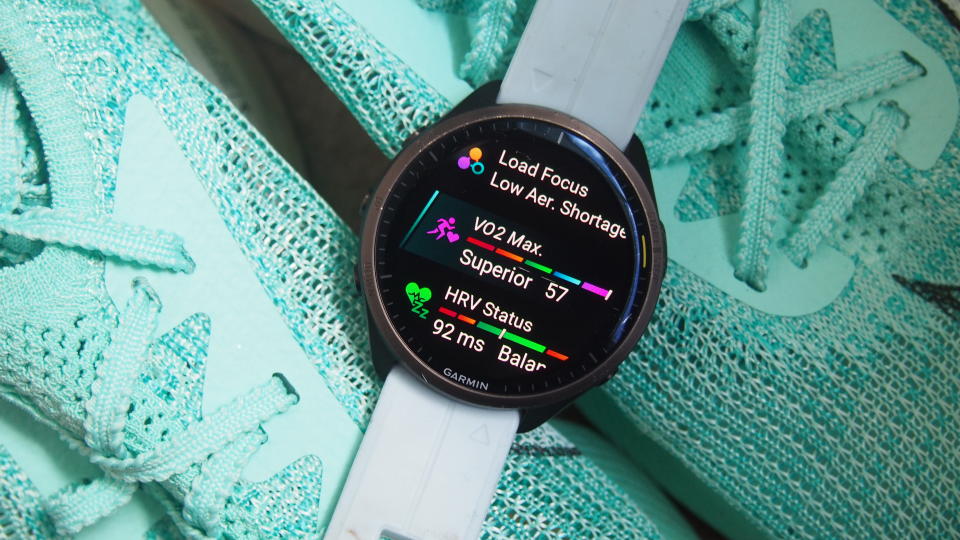 Garmin watch with VO2 Max readings on a pair of trainers