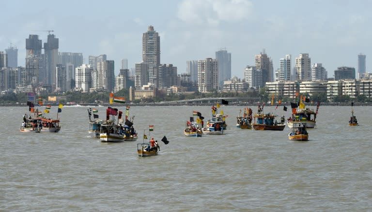 Fishing boats adorned with black flags take part in a 'Sea-Rally' to protest against the construction of The Chhatrapati Shivaji Memorial in the Arabian Sea off the coast of Mumbai on May 25, 2016