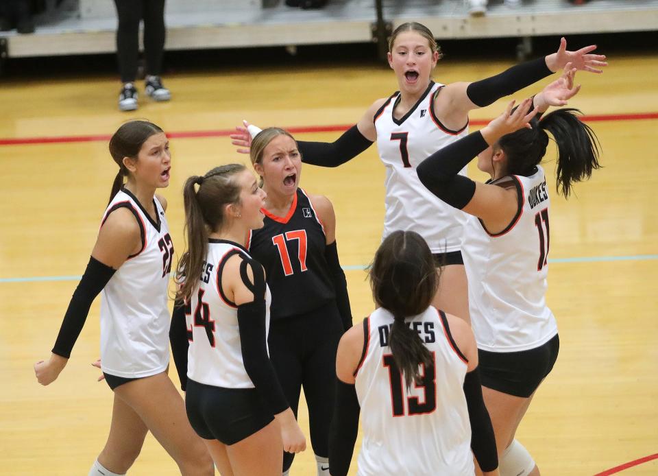 The Marlington volleyball team celebrates after a point during a five-set win over Kenston in a regional semifinal, Thursday, Nov. 2, 2023.