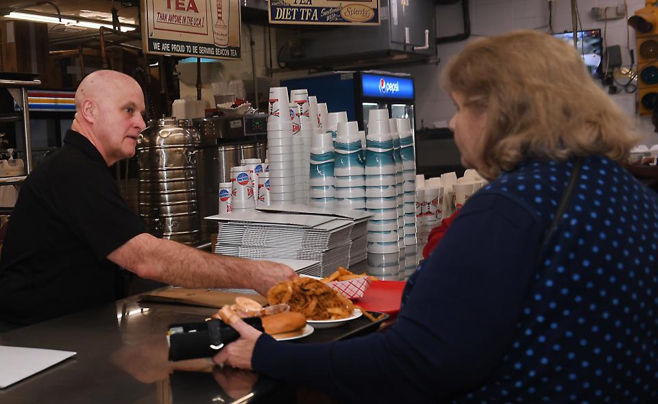 The Beacon Drive-In in Spartanburg was named one of the best burger restaurants in the South by Southern Living. This is Steve Duncan one of the owner/operators of the restaurant. Here, Duncan, left, brings a guest her meal.