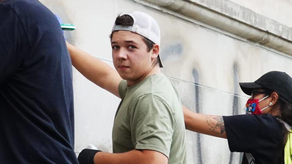 <div class="inline-image__caption"><p>Volunteers clean graffiti from a high school near the Kenosha County Courthouse following another night of unrest.</p></div> <div class="inline-image__credit">Scott Olson/Getty</div>