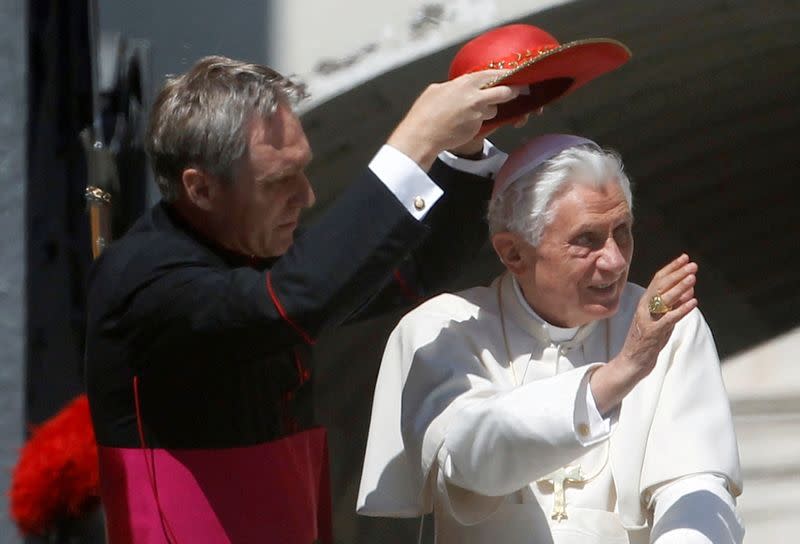 FILE PHOTO: Pope Benedict XVI's secretary Ganswein adjusts his hat as they arrive for the weekly audience in Saint Peter's Square at the Vatican