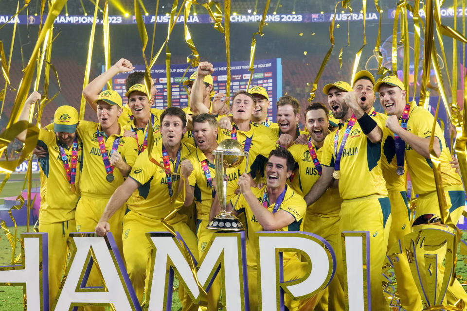 Australia players celebrate with the trophy after Australia won the ICC Men's Cricket World Cup final match against India in Ahmedabad, India, Sunday, Nov. 19, 2023. (AP Photo/Rafiq Maqbool)