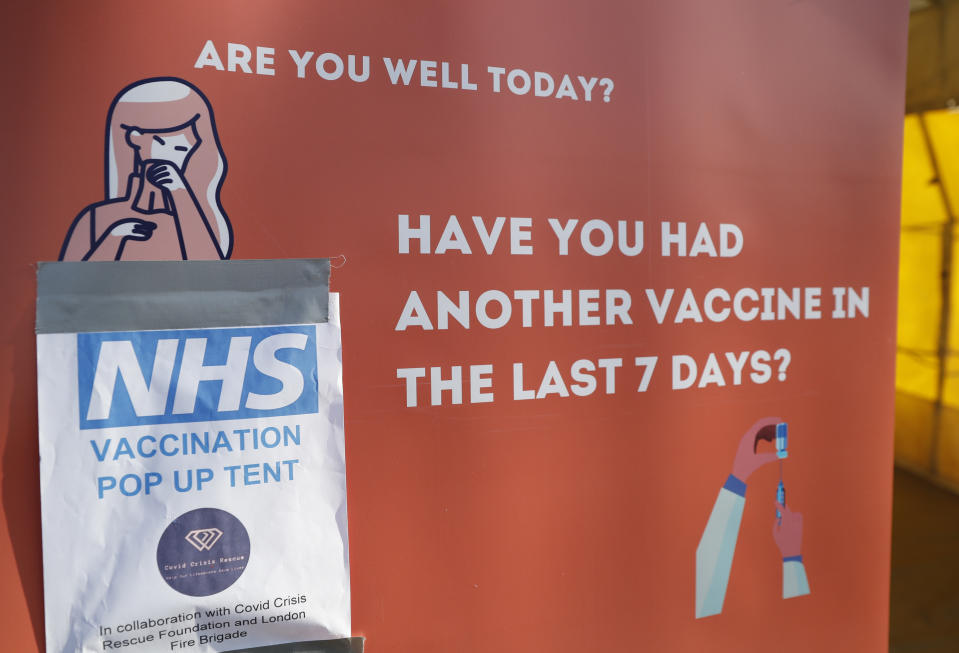 A sign outside the vaccination tent during the pilot project of pop up vaccination drive 'Vaxi Taxi' in Kilburn, London, Sunday, Feb. 28, 2021. The pilot scheme, funded by the Covid Crisis Rescue Foundation, aims to help ferry supplies and patients to temporary clinics set up in faith and community centres across the capital. People don’t even need to leave the backseat if they didn’t want to in order to receive their inoculation. (AP Photo/Alastair Grant)