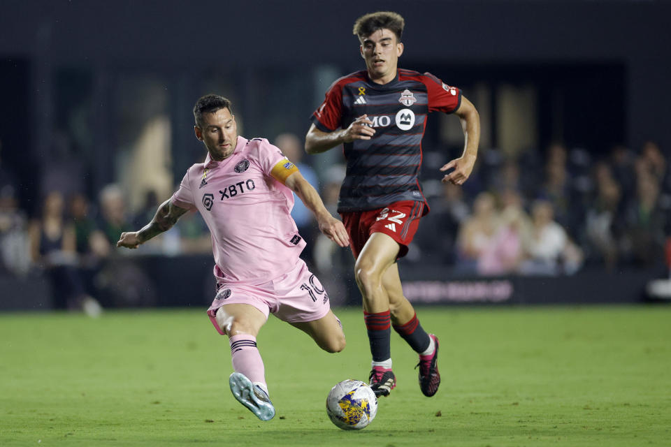 FORT LAUDERDALE, FLORIDA - SEPTEMBER 20: Lionel Messi #10 of Inter Miami takes a shot during the first half while defended by  Alonso Coello #52 of Toronto FC at DRV PNK Stadium on September 20, 2023 in Fort Lauderdale, Florida. (Photo by Carmen Mandato/Getty Images)