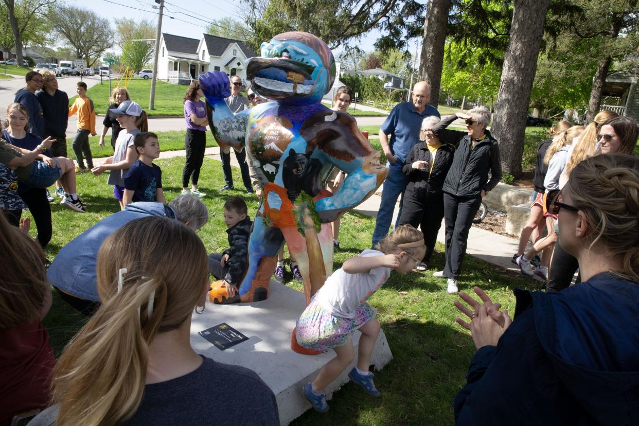 Spectators gather around Archer Damschen’s America’s Best Idea Herky statue Wednesday, May 1, 2024 in University Heights, Iowa. Damschen’s Herky was sponsored by Johnson County Conservation and the city of University Heights.