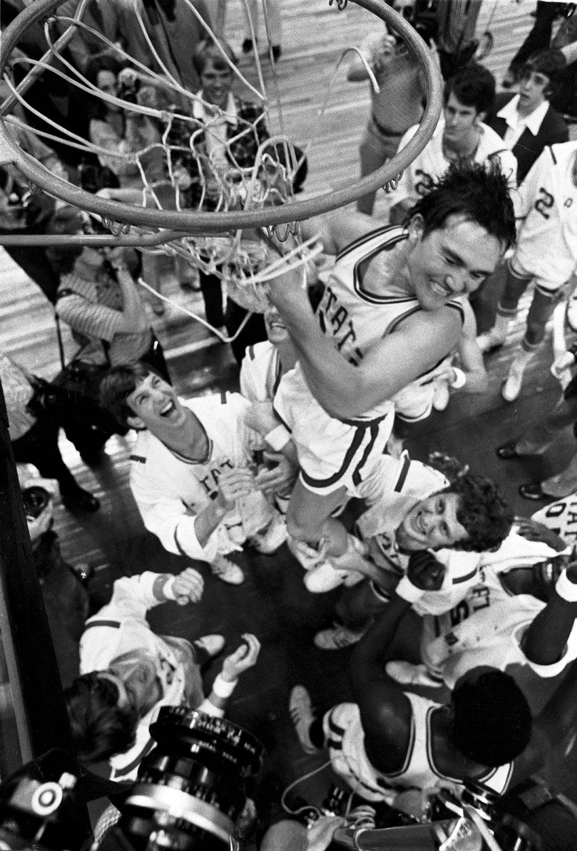 NC State point guard Monte Towe cuts down the nets after the Wolfpack defeated Maryland to win the ACC Tournament in Greensboro, NC in 1974.