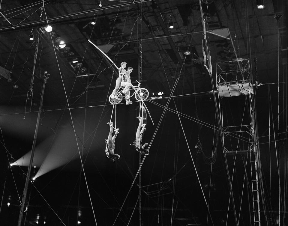 <p>Harold Alzanas on the bicycle during the high wire Alzanas act of the big show now attracting kids of all ages at Madison Square Garden, New York, April 12, 1951. (AP Photo/Ed Ford) </p>