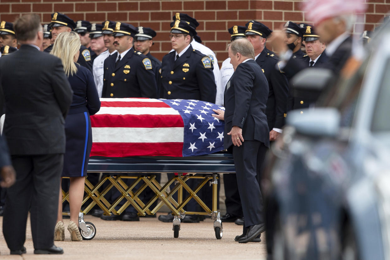 A person touches the casket of Aaron Salter Jr. during a funeral service in Getzville, N.Y., on May 25, 2022. (Joshua Bessex / AP file)