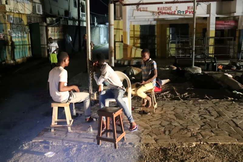 People are seen outside their home after tremors shook buildings, following Saturday's earthquake in Les Cayes, Haiti