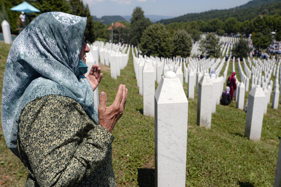A woman prays during the funerals of nine massacre victims in Potocari, near Srebrenica, Bosnia, Saturday, July 11, 2020. Mourners converged on the eastern Bosnian town of Srebrenica for the 25th anniversary of the country's worst carnage during the 1992-95 war and the only crime in Europe since World War II that has been declared a genocide. (AP Photo/Kemal Softic)