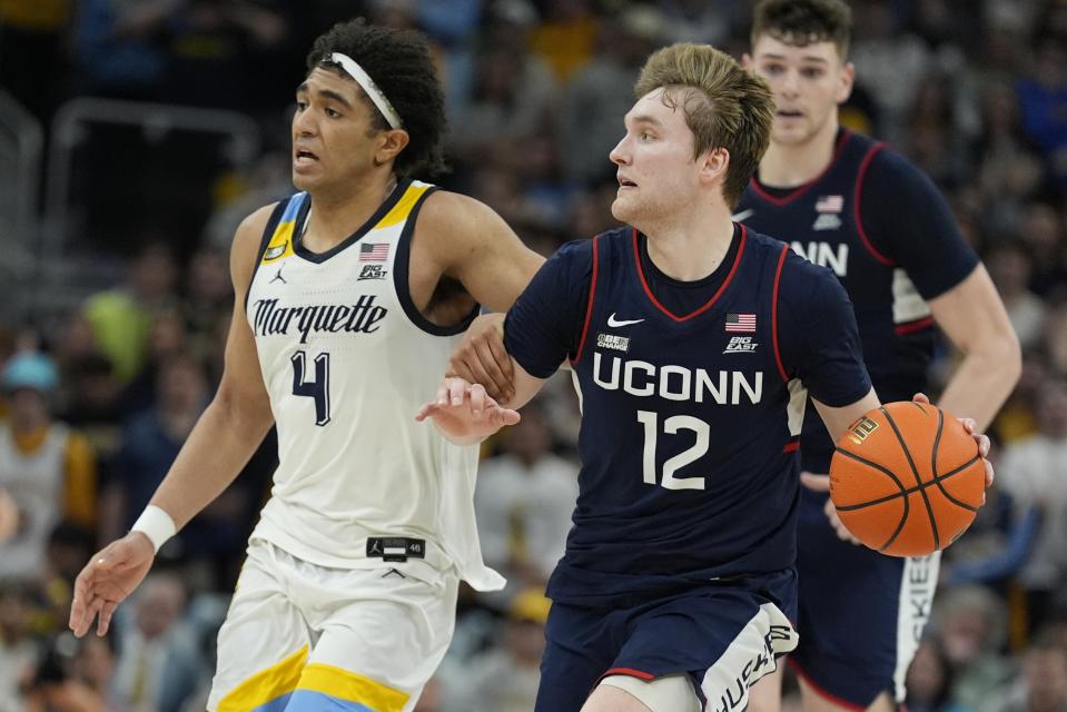 UConn's Cam Spencer tries to get past Marquette's Stevie Mitchell during the second half of an NCAA college basketball game Wednesday, March 6, 2024, in Milwaukee. UConn won 74-67. (AP Photo/Morry Gash)