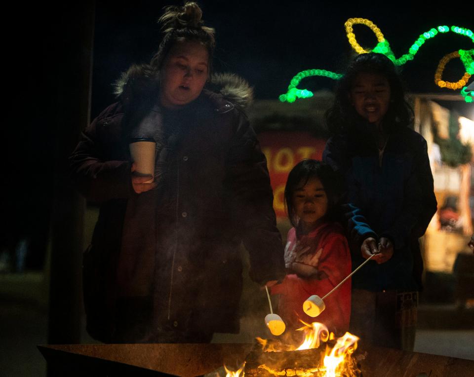 Kaitlyn Waldo, Angelina Liv and Arlenna Siv roast marshmallows at Starry Nights, annual drive-through light display at Shelby Farms, Tuesday, Dec. 11, 2018.