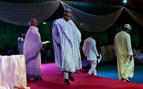 Nigerian President Muhammadu Buhari walks to the lectern to address the crowd gathered at an electoral commission ceremony in Abuja - Credit: AP