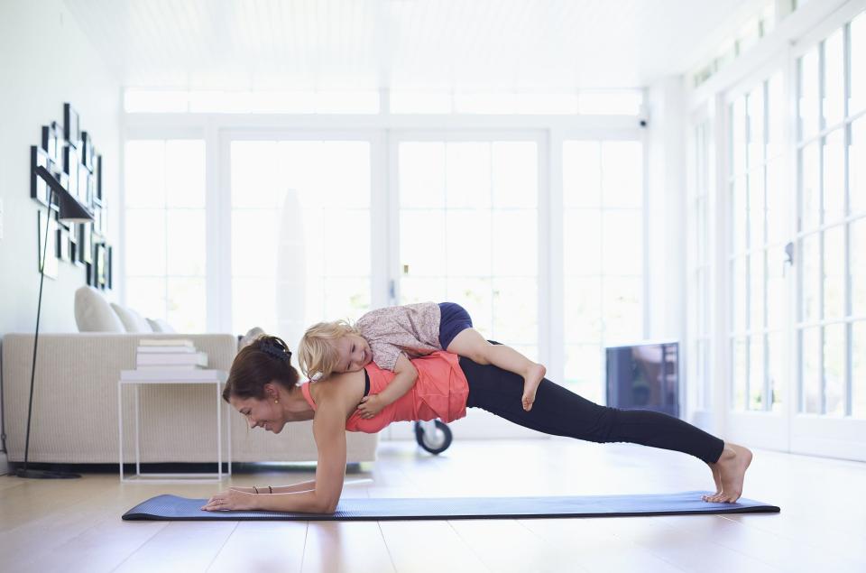 mom doing yoga with toddler