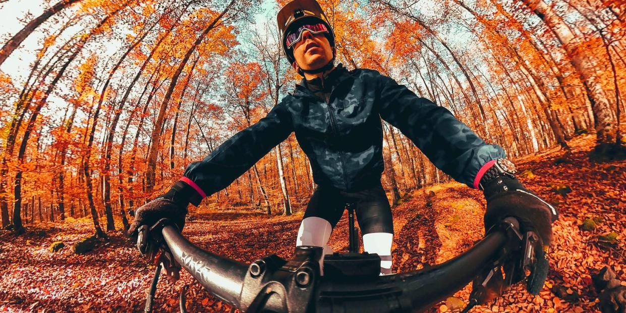 creative selfie picture riding mountain bike in autumn forest in spain