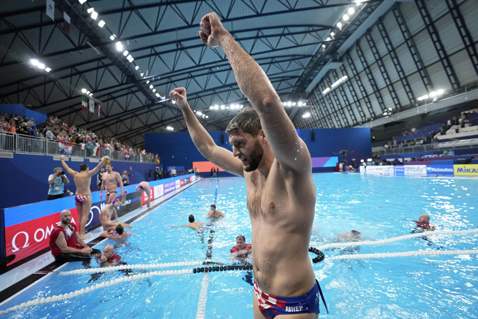 Croatia players celebrate in the pool at the end of the men's water polo final match between Italy and Croatia at the World Aquatics Championships in Doha, Qatar, Saturday, Feb. 17, 2024. Croatia defeated Italy 15-13. (AP Photo/Lee Jin-man)