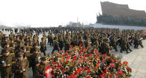 North Koreans offer flowers at Mansudae in Pyongyang on the eve of the second anniversary of the death of former leader Kim Jong Il, in this undated photo released by North Korea's Korean Central News Agency (KCNA) in Pyongyang on December 16, 2013. (REUTERS/KCNA)