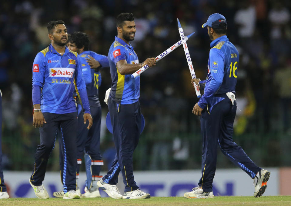 Sri Lankan team members from left, Shehan Jayasuriya, Lahiru Kumara and captain Dimuth Karunaratne celebrate their team's victory over Bangladesh by 122 runs in the third one-day international cricket match between Sri Lanka and Bangladesh in Colombo, Sri Lanka, Wednesday, July 31, 2019. (AP Photo/Eranga Jayawardena)