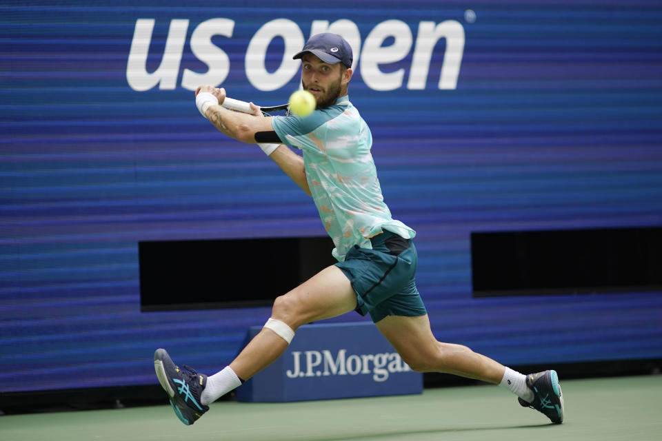 Corentin Moutet, of France, steps to return to Casper Ruud, of Norway, during the fourth round of the U.S. Open tennis championships, Sunday, Sept. 4, 2022, in New York. (AP Photo/Eduardo Munoz Alvarez)