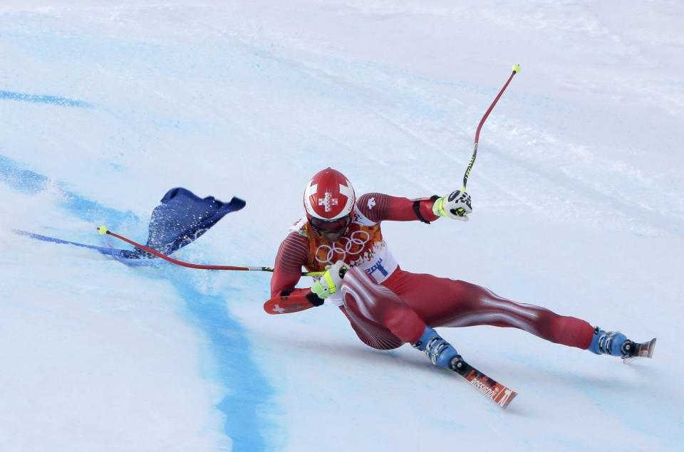 Switzerland's Didier Defago falls in the men's super-G at the Sochi 2014 Winter Olympics, Sunday, Feb. 16, 2014, in Krasnaya Polyana, Russia. (AP Photo/Charlie Riedel)