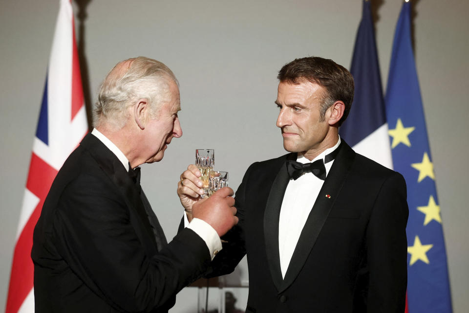 French President Emmanuel Macron, right, and Britain's King Charles III toast during a state dinner in the Hall of Mirrors at the Chateau de Versailles in Versailles, west of Paris, Wednesday, Sept. 20, 2023. President Emmanuel Macron and King Charles III held talks in Paris on Wednesday at the start of a long-awaited three-day state visit meant to highlight the friendship between France and the U.K. (Benoit Tessier/Pool via AP)