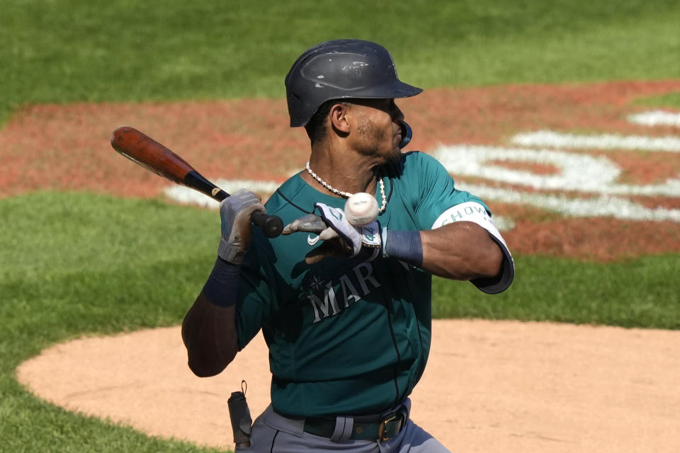 Seattle Mariners' Julio Rodriguez is hit by Chicago White Sox's Gregory Santos' pitch during the ninth inning of a baseball game Wednesday, Aug. 23, 2023, in Chicago. (AP Photo/Charles Rex Arbogast)