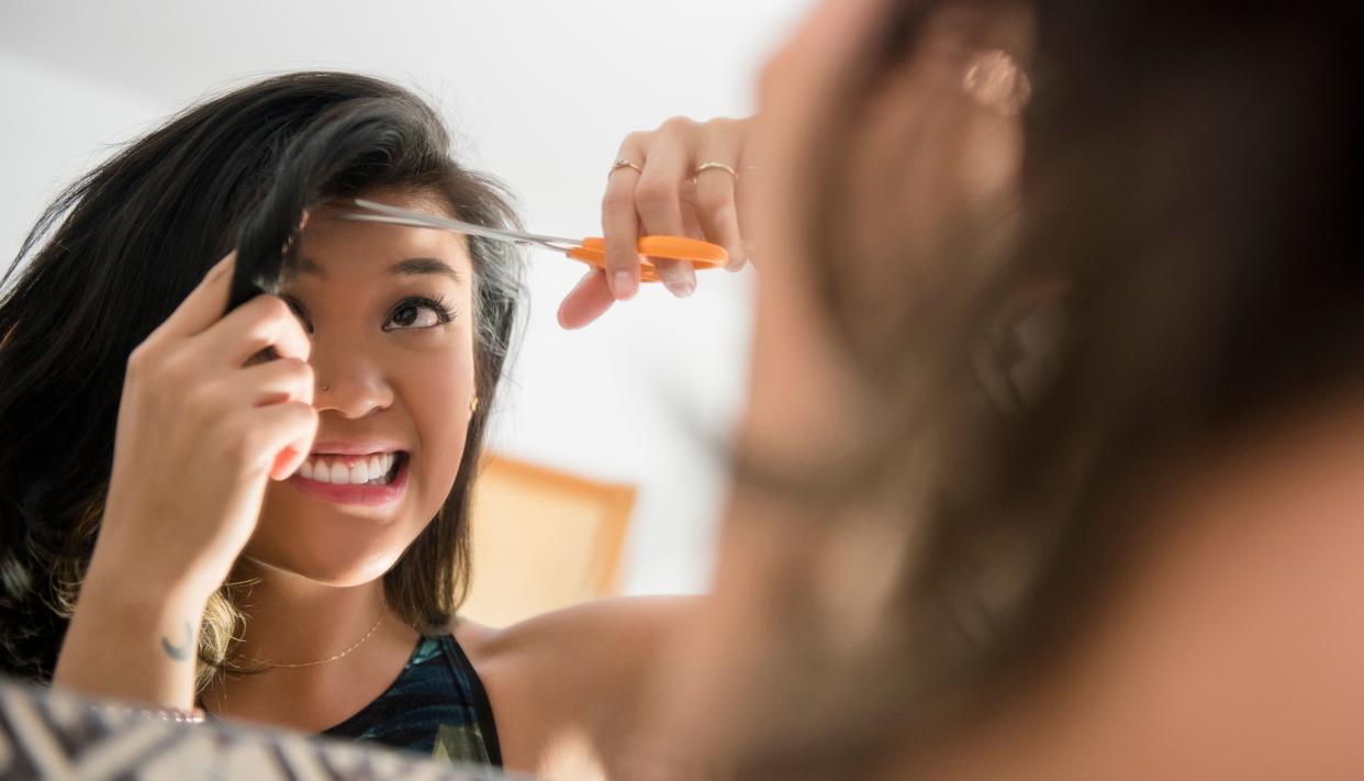 No matter how you feel about bangs, growing them out sucks. (Photo: JGI/Jamie Grill via Getty Images)